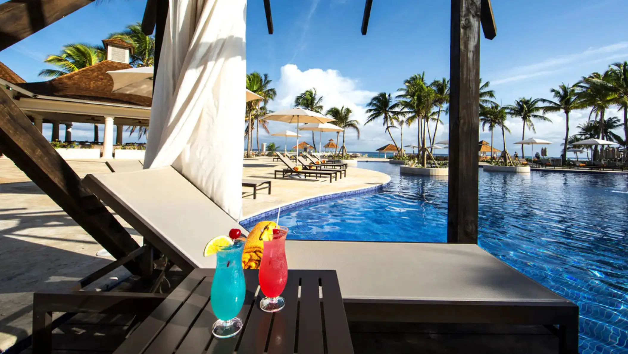 Hyatt Ziva Rose Hall pool and cabana with tropical cocktails, Montego Bay