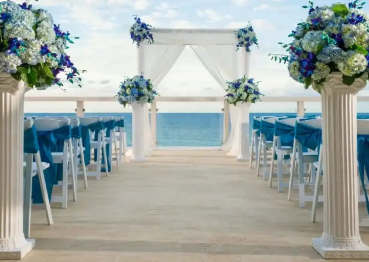 Sky Lounge wedding ceremony with blue floral arrangements at Hyatt Ziva Rose Hall, Montego Bay