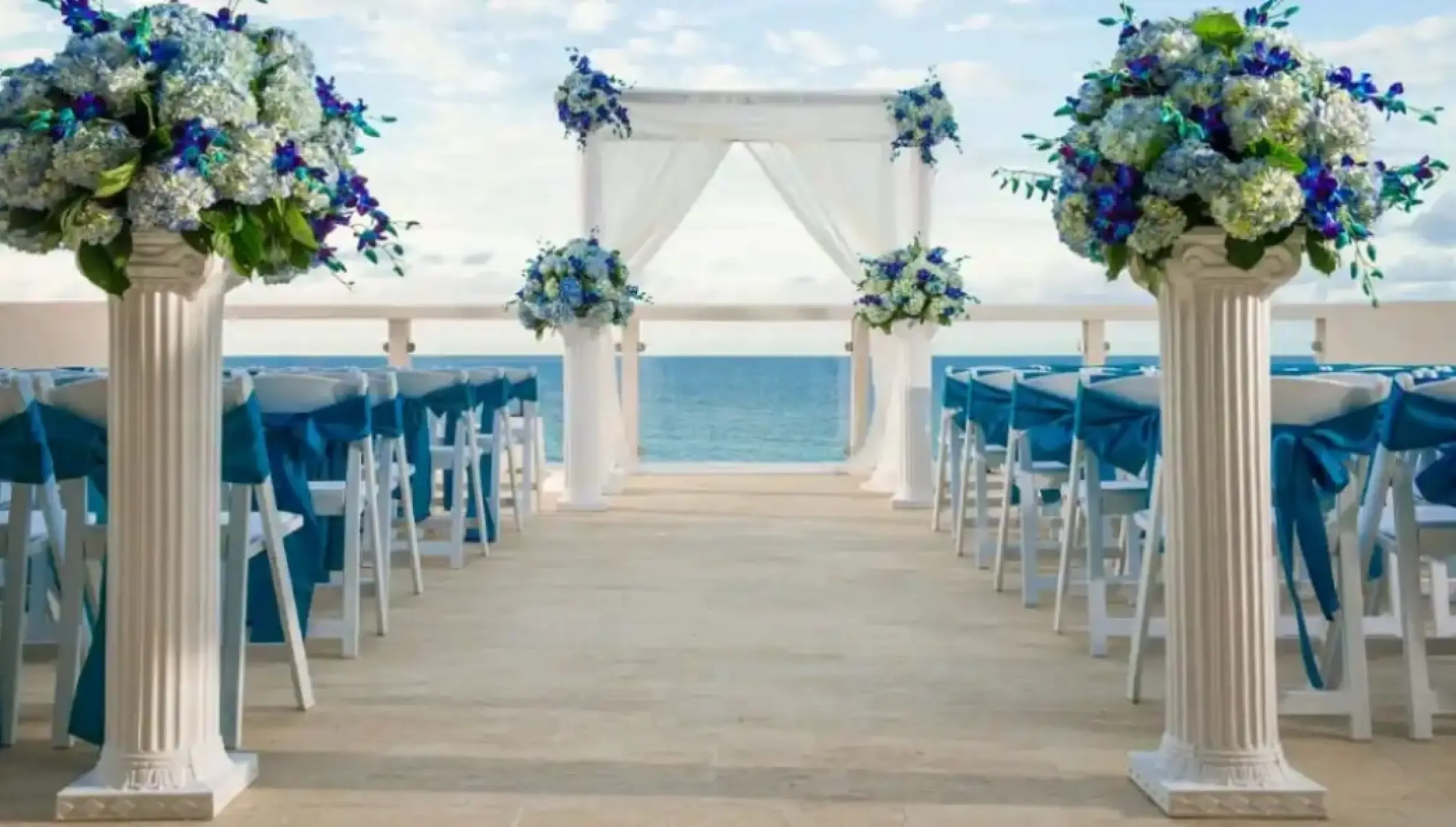 Sky Lounge wedding ceremony with blue floral arrangements at Hyatt Ziva Rose Hall, Montego Bay