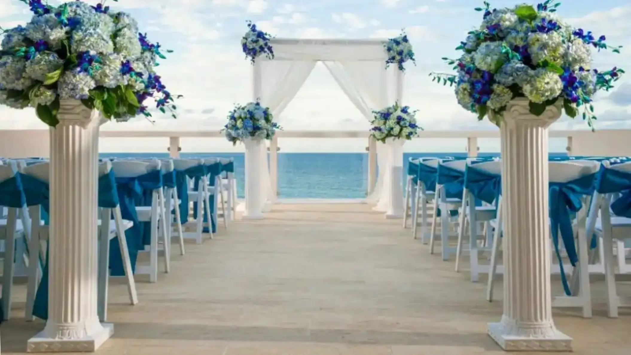 Sky Lounge wedding ceremony with blue floral arrangements at Hyatt Ziva Rose Hall, Montego Bay