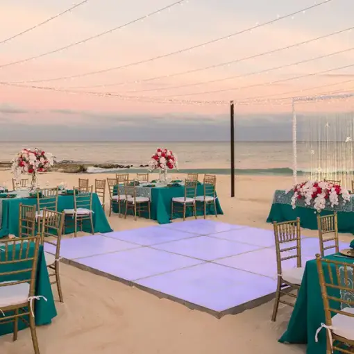 Beachfront wedding reception at JOIA Paraiso by Iberostar featuring a dance floor and turquoise linens in Riviera Maya
