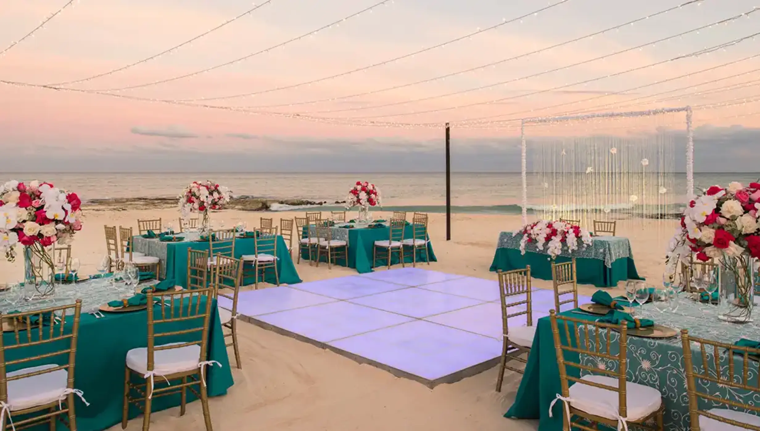 Iberostar Grand Paraiso beach wedding venue with dance floor, tables and chairs