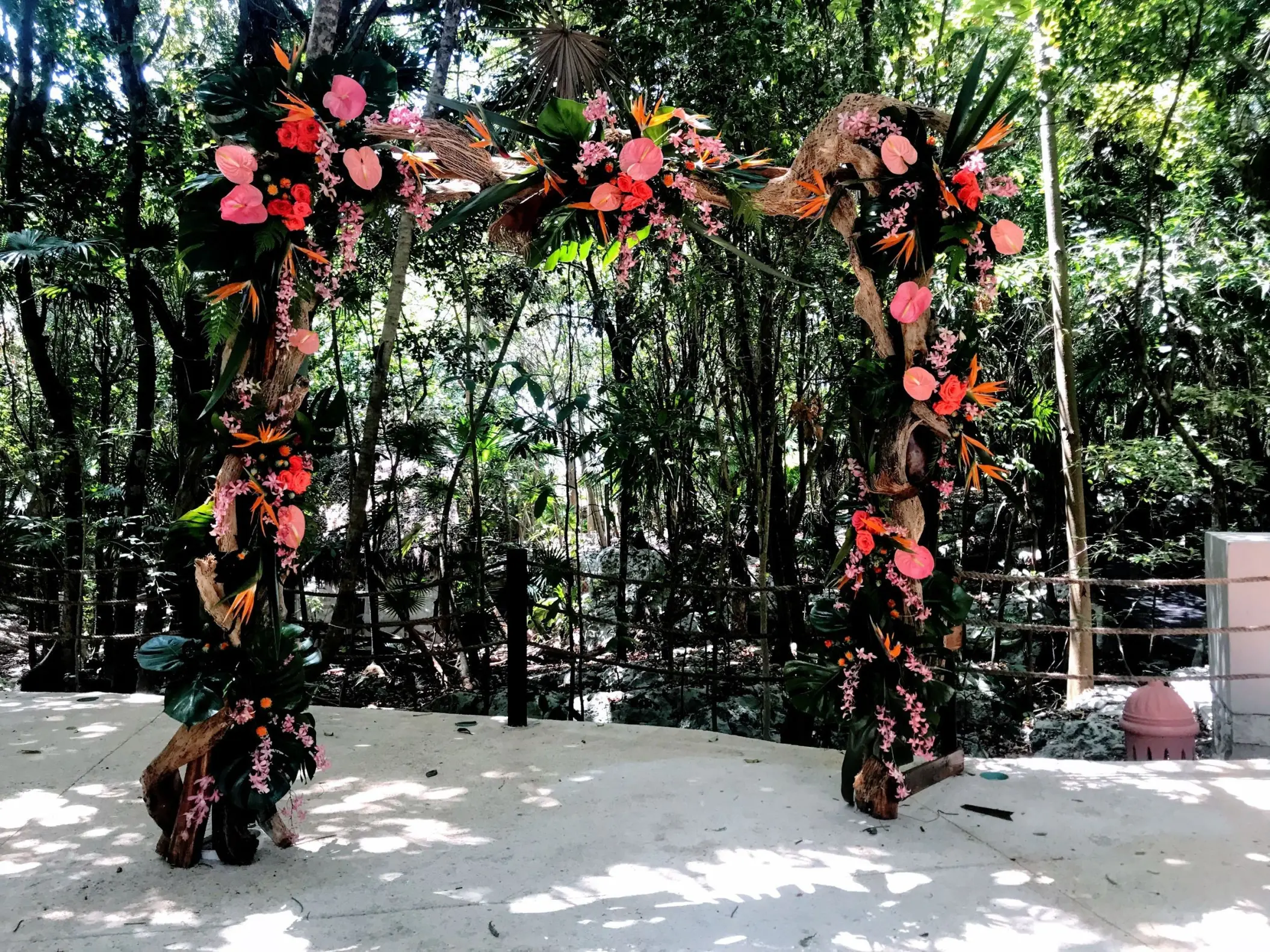 Jungle wedding ceremony arch with pink flowers at Iberostar Waves Quetzal, Playa Del Carmen