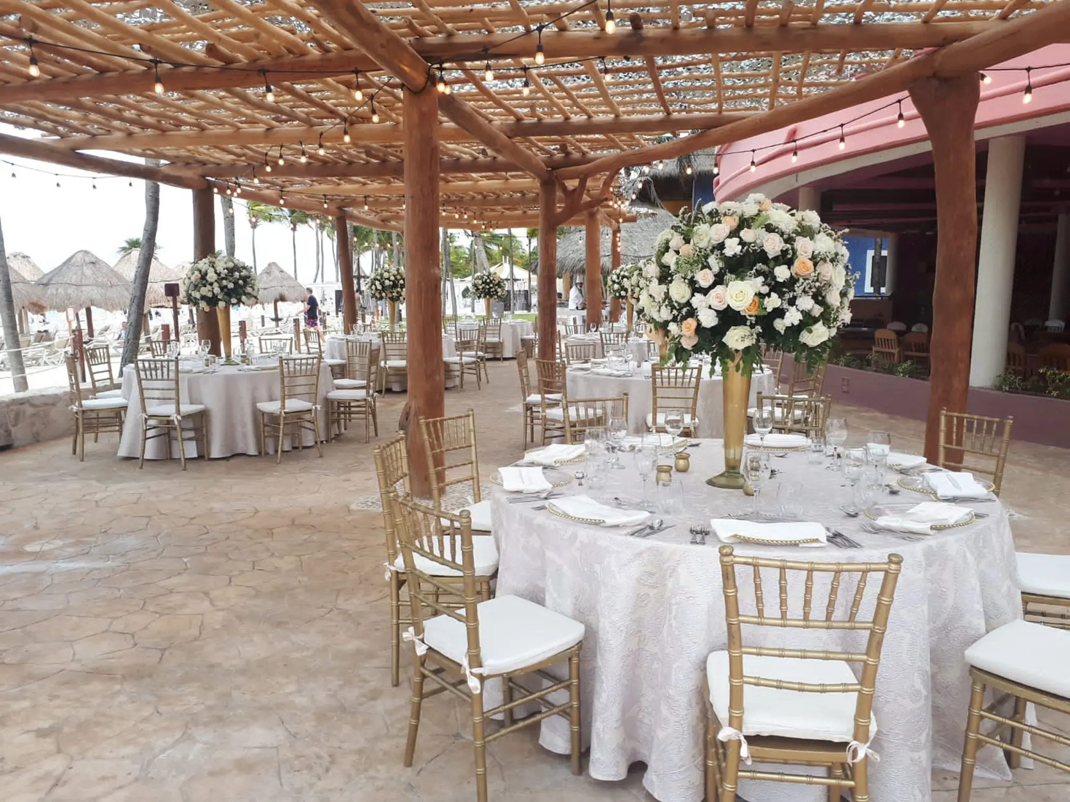 Wedding reception under a wooden pergola at Iberostar Waves Quetzal, Playa Del Carmen
