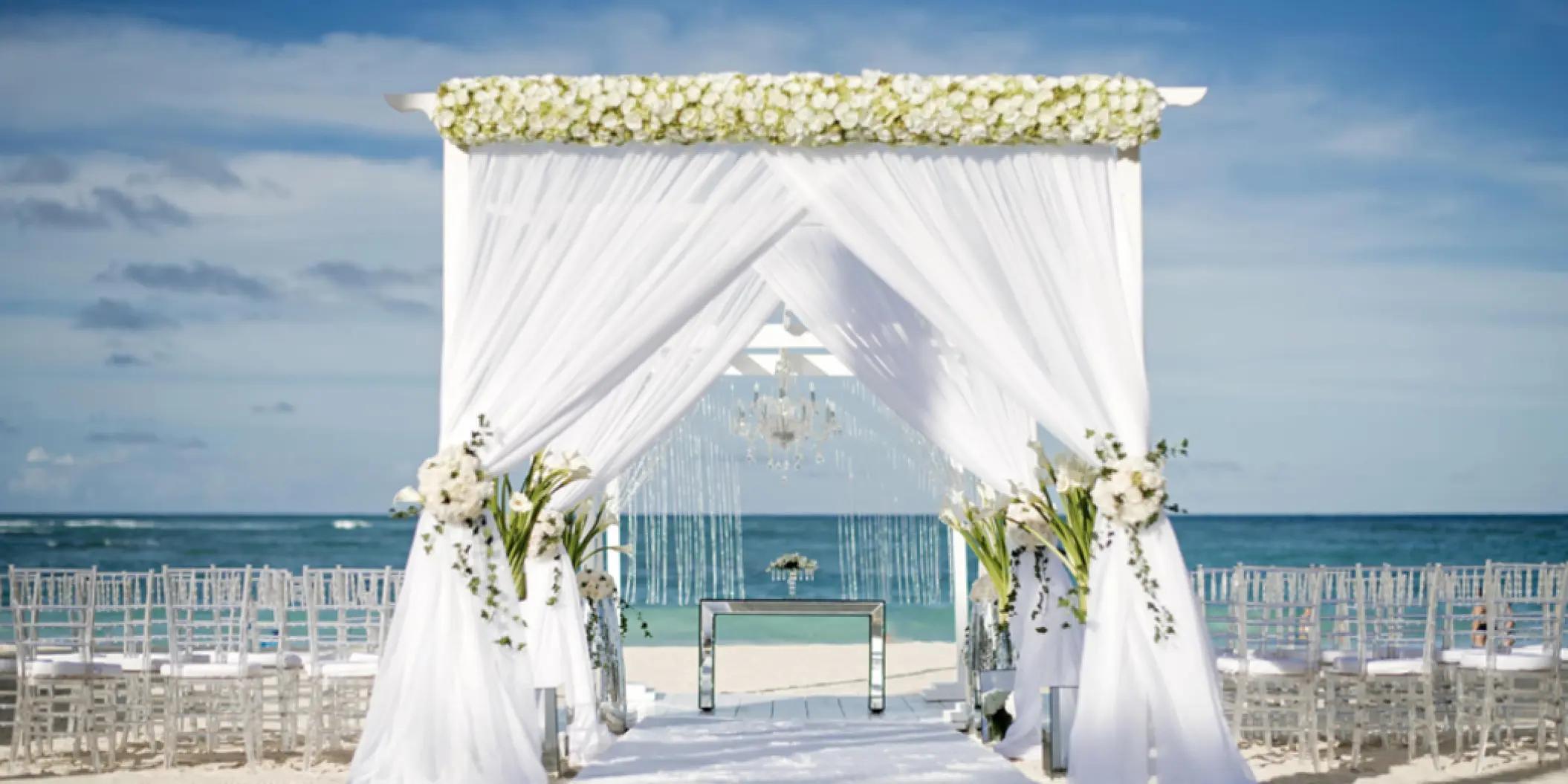 Beachfront wedding ceremony setup with a white draped huppah at Iberostar Selection Bavaro, Punta Cana