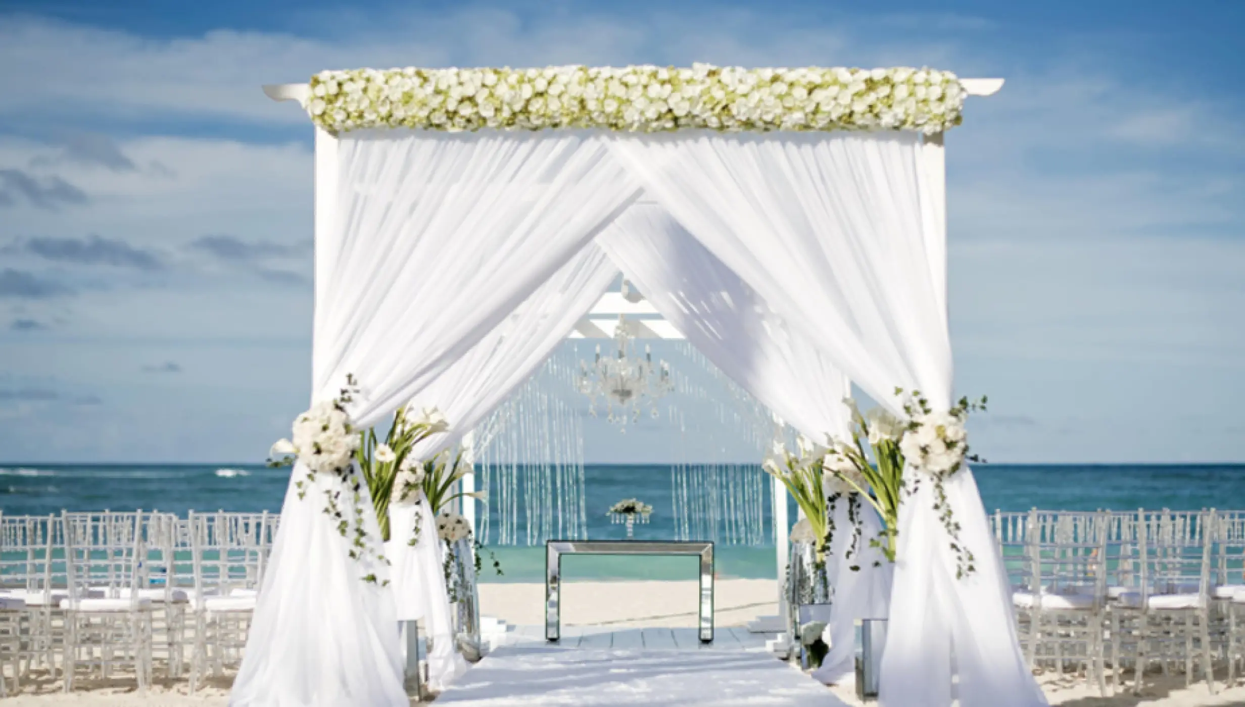 Beachfront wedding ceremony setup with a white draped huppah at Iberostar Selection Bavaro, Punta Cana
