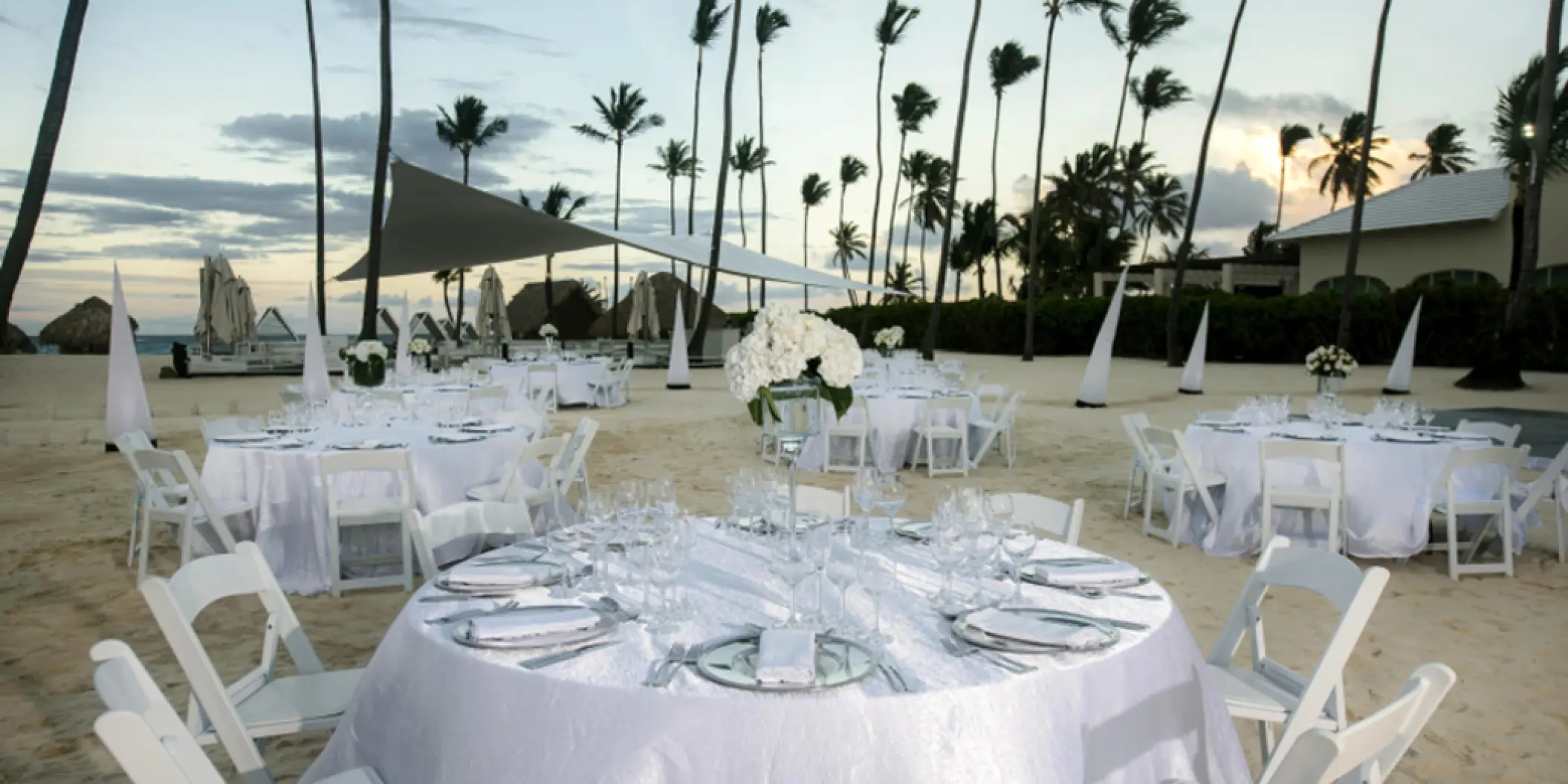 Beachfront wedding reception tables with white linens at Iberostar Selection Bavaro, Punta Cana