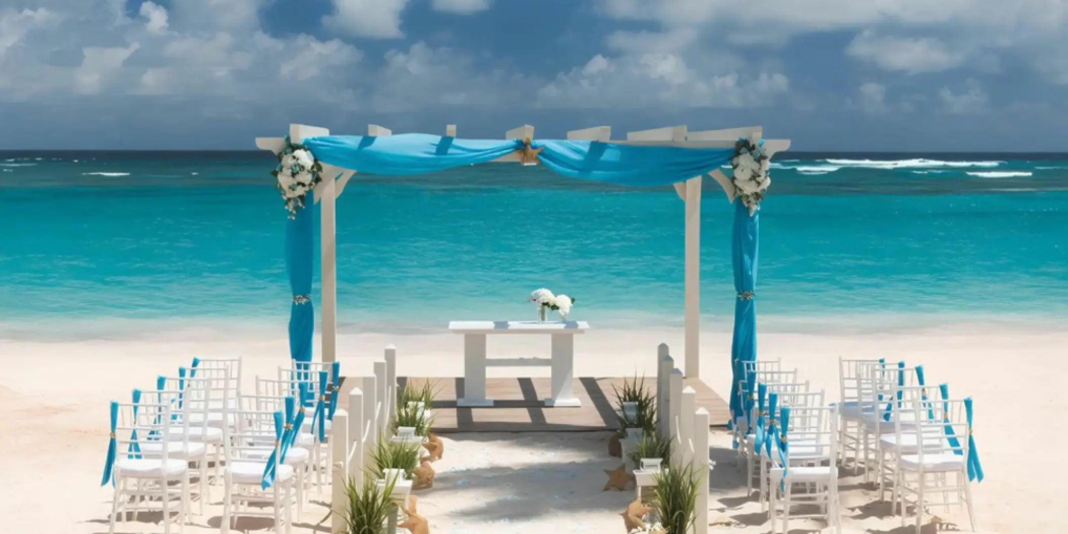 Beachfront wedding ceremony setup with turquoise drapery at Iberostar Selection Bavaro, Punta Cana