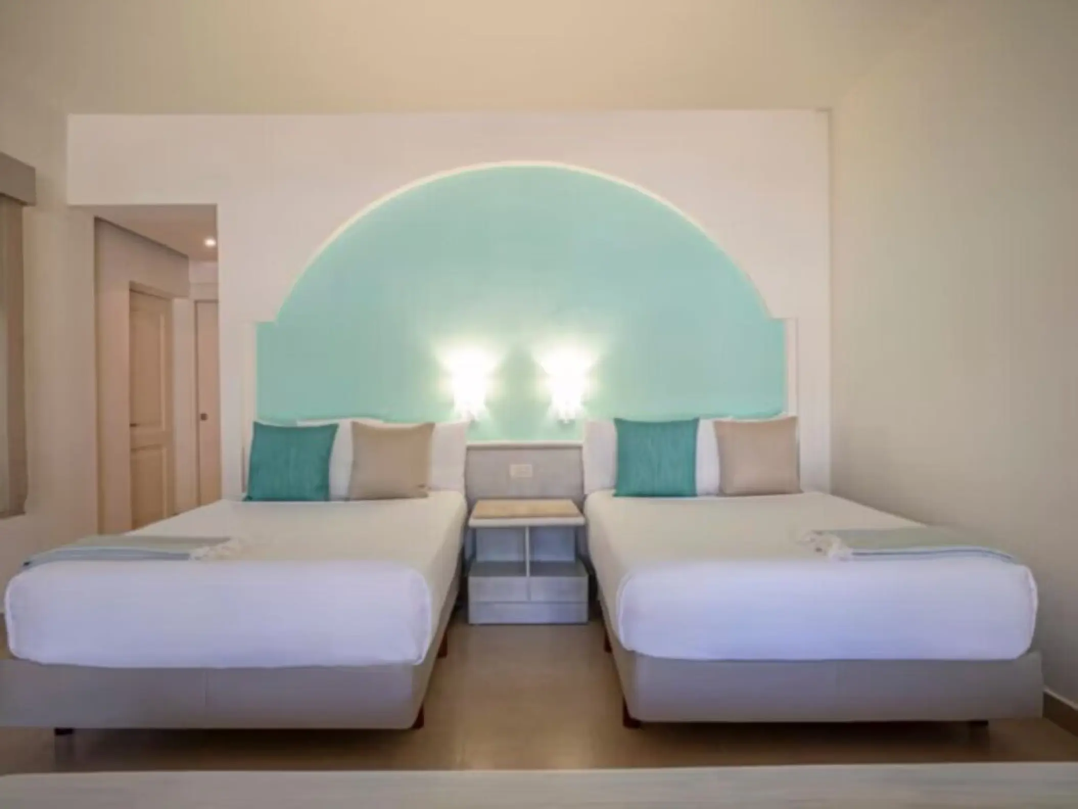 Double bed suite with teal accents at Iberostar Selection Bavaro, Punta Cana