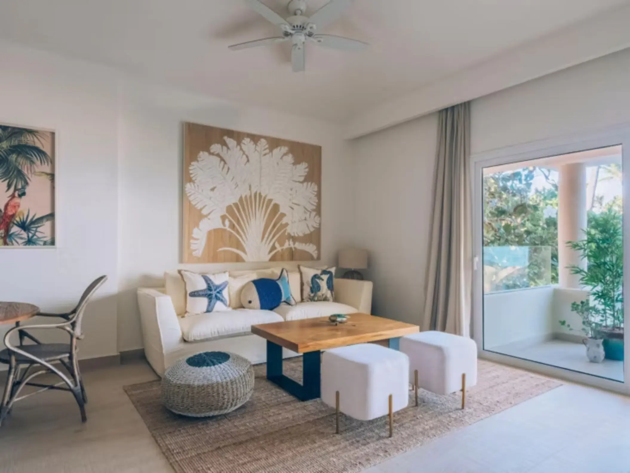 Living area with a sofa and balcony in a suite at Iberostar Selection Bavaro, Punta Cana