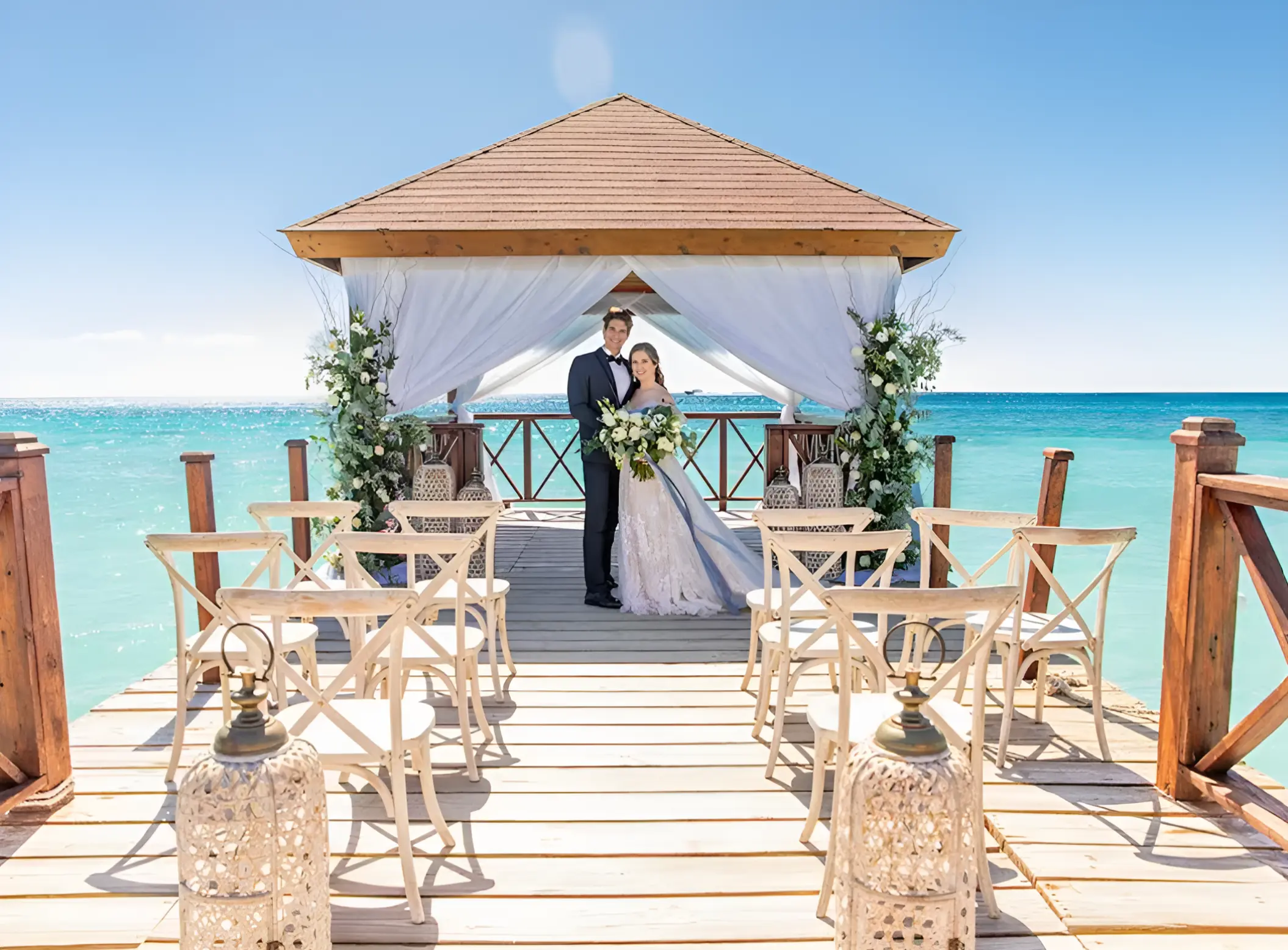 Bride and groom under a pier gazebo for a wedding ceremony at Iberostar Hacienda Dominicus, La Romana