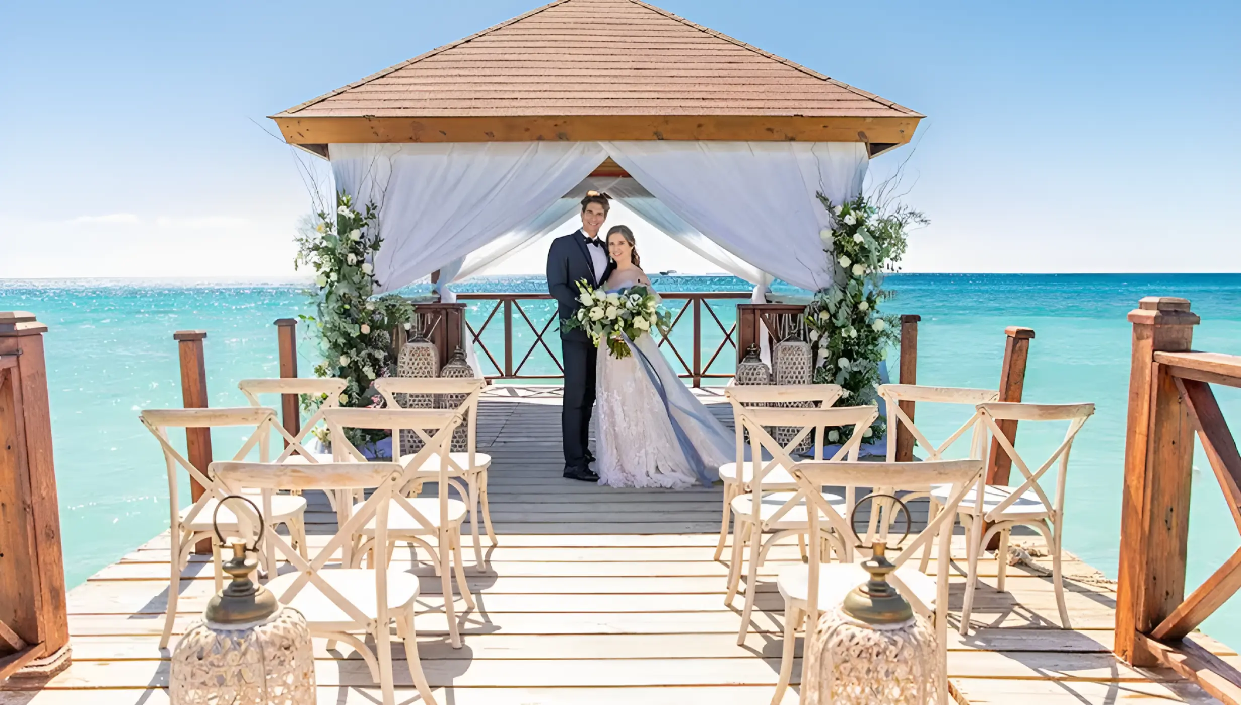 Bride and groom under a pier gazebo for a wedding ceremony at Iberostar Hacienda Dominicus, La Romana