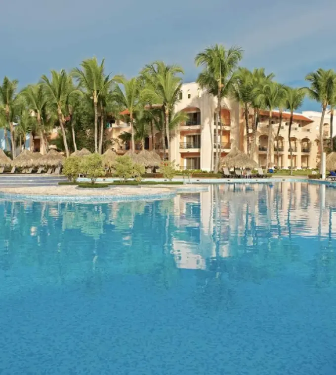 Large swimming pool and colonial-style buildings at Iberostar Selection Hacienda Dominicus, La Romana