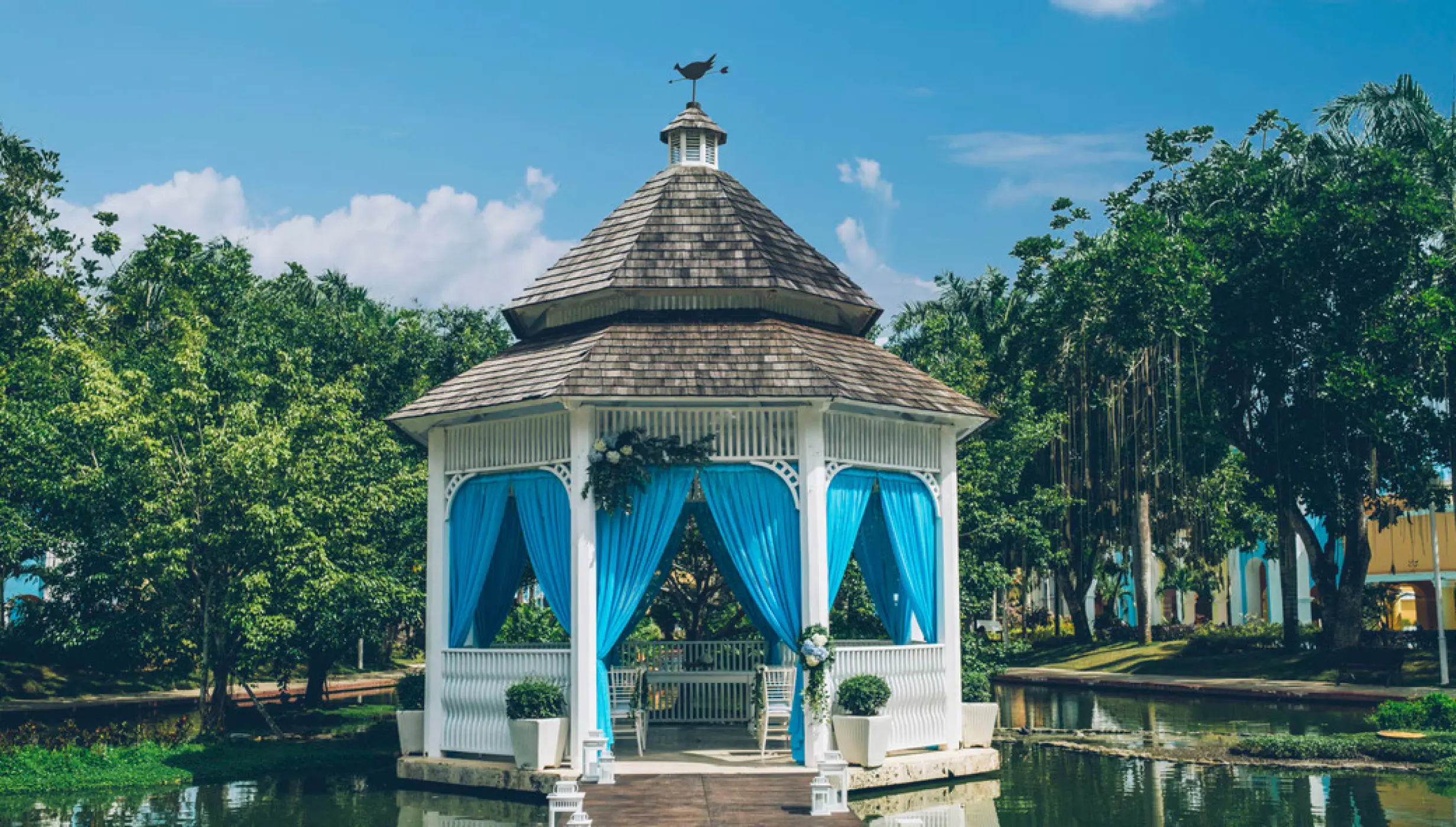 White garden wedding gazebo with blue curtains at Iberostar Selection Hacienda Dominicus, La Romana