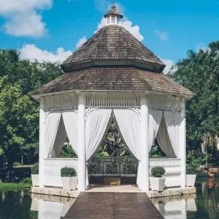 Lake gazebo wedding venue with white curtains at Iberostar Selection Hacienda Dominicus, La Romana