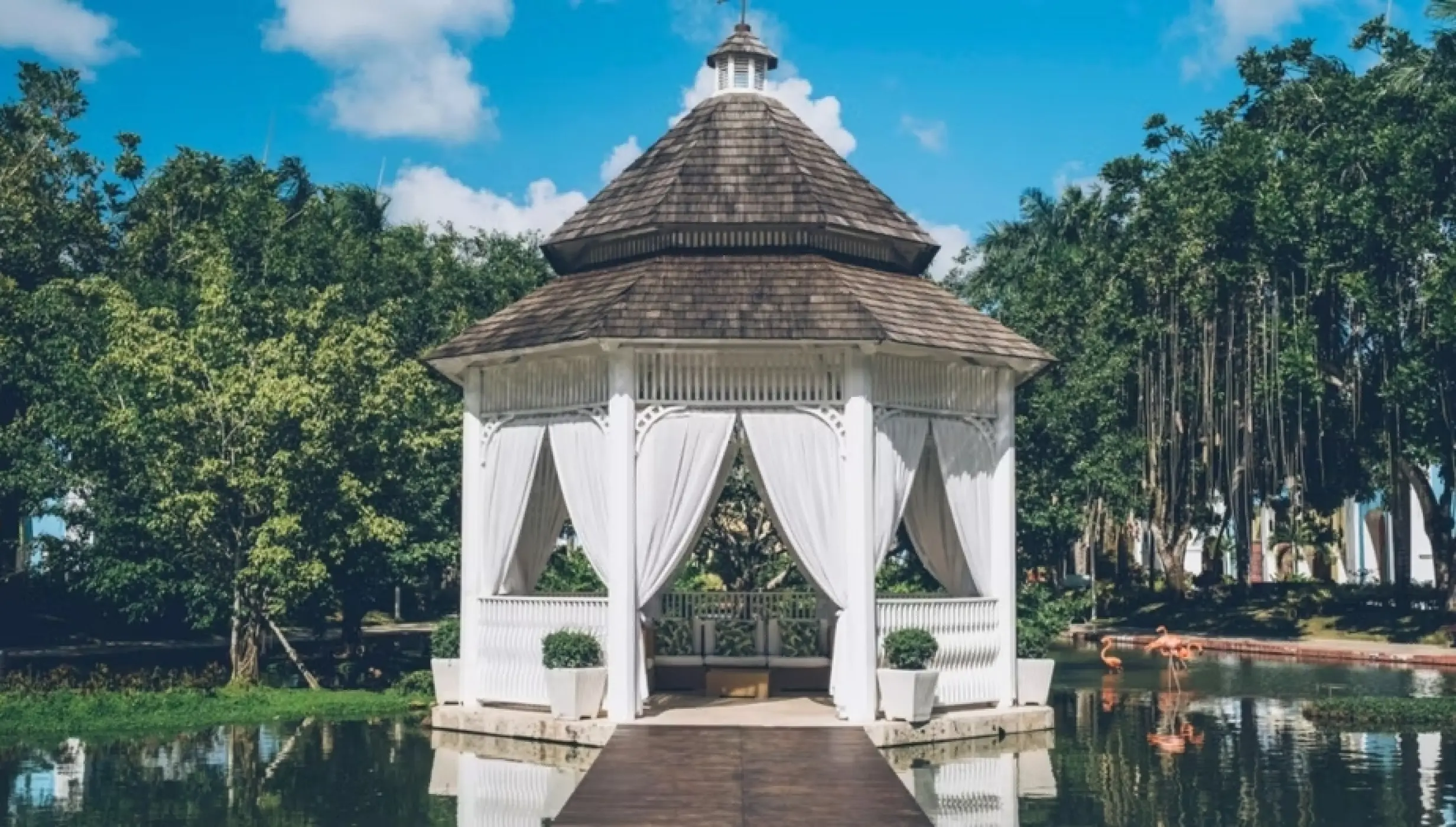 Lake gazebo wedding venue with white curtains at Iberostar Selection Hacienda Dominicus, La Romana