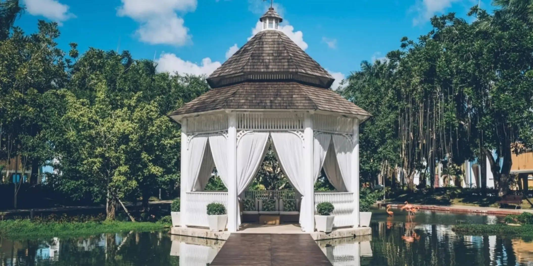Lake gazebo wedding venue with white curtains at Iberostar Selection Hacienda Dominicus, La Romana