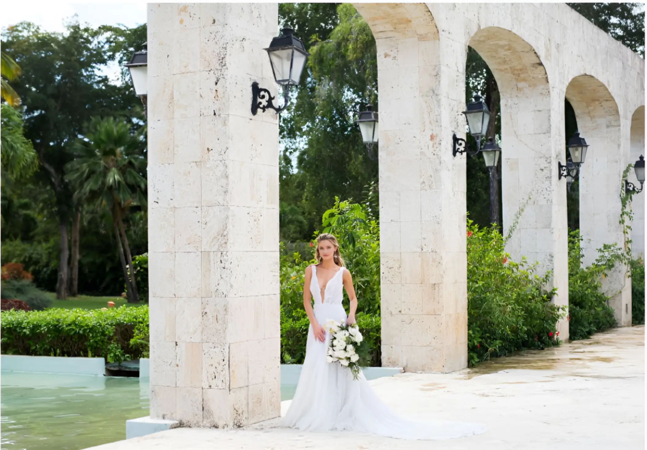 Bride posing under the stone arches at Iberostar Selection Hacienda Dominicus, La Romana