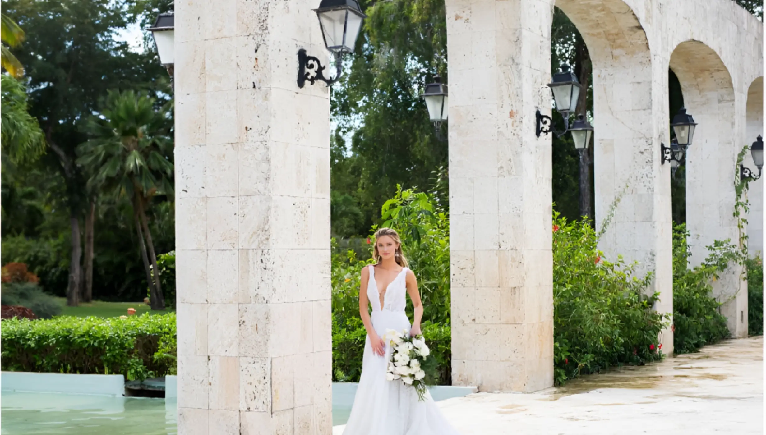 Bride posing under the stone arches at Iberostar Selection Hacienda Dominicus, La Romana