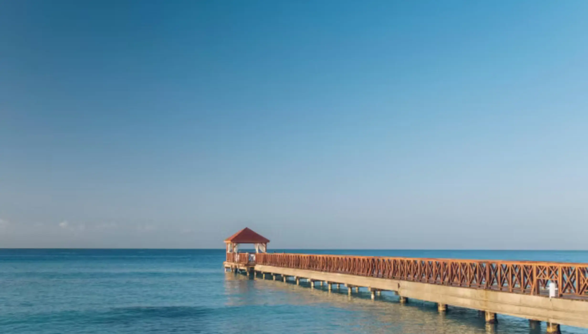 Wooden pier wedding venue over turquoise water at Iberostar Selection Hacienda Dominicus, La Romana