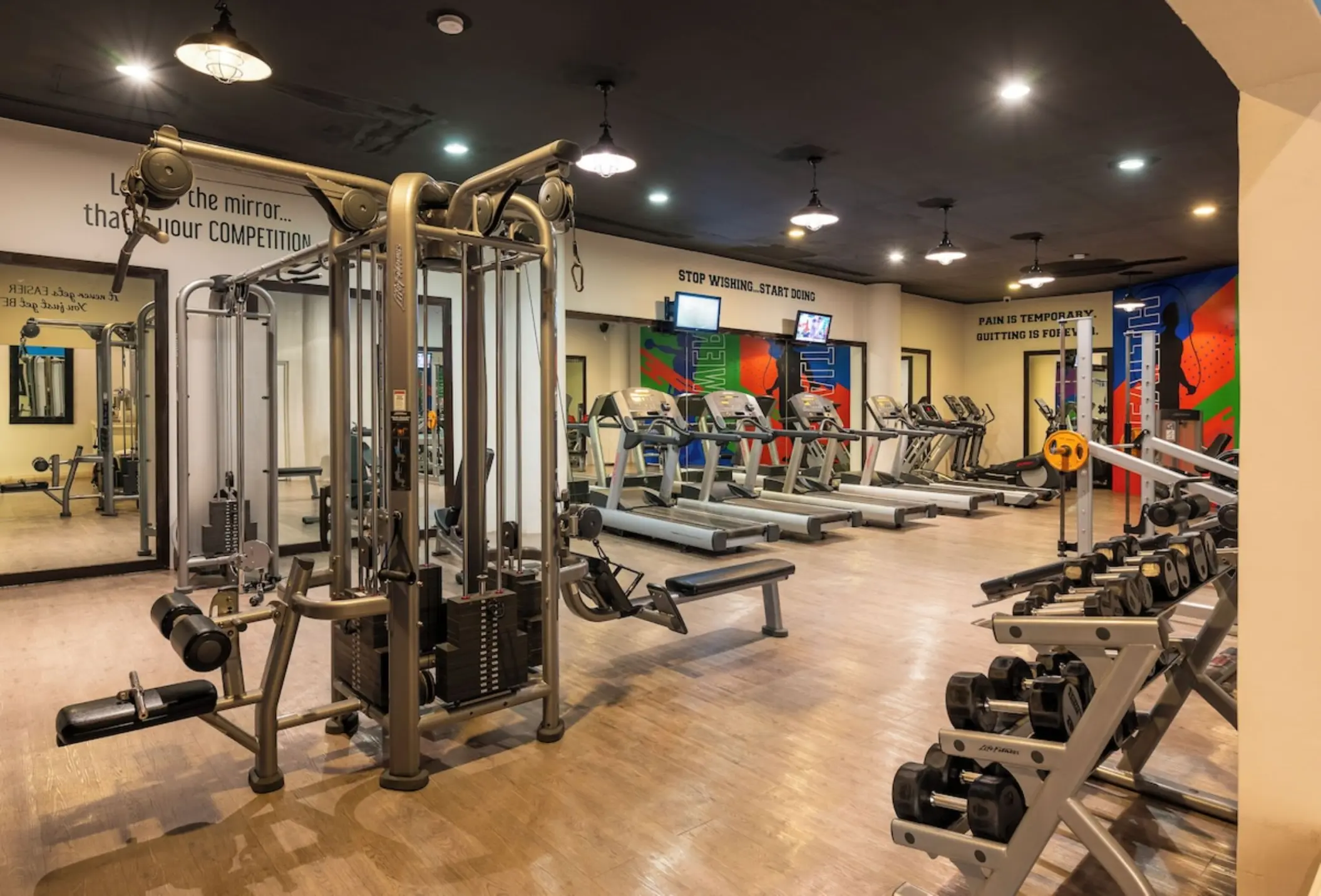 Weight machines, treadmills, and dumbbells in the gym at Iberostar Selection Riviera Cancun