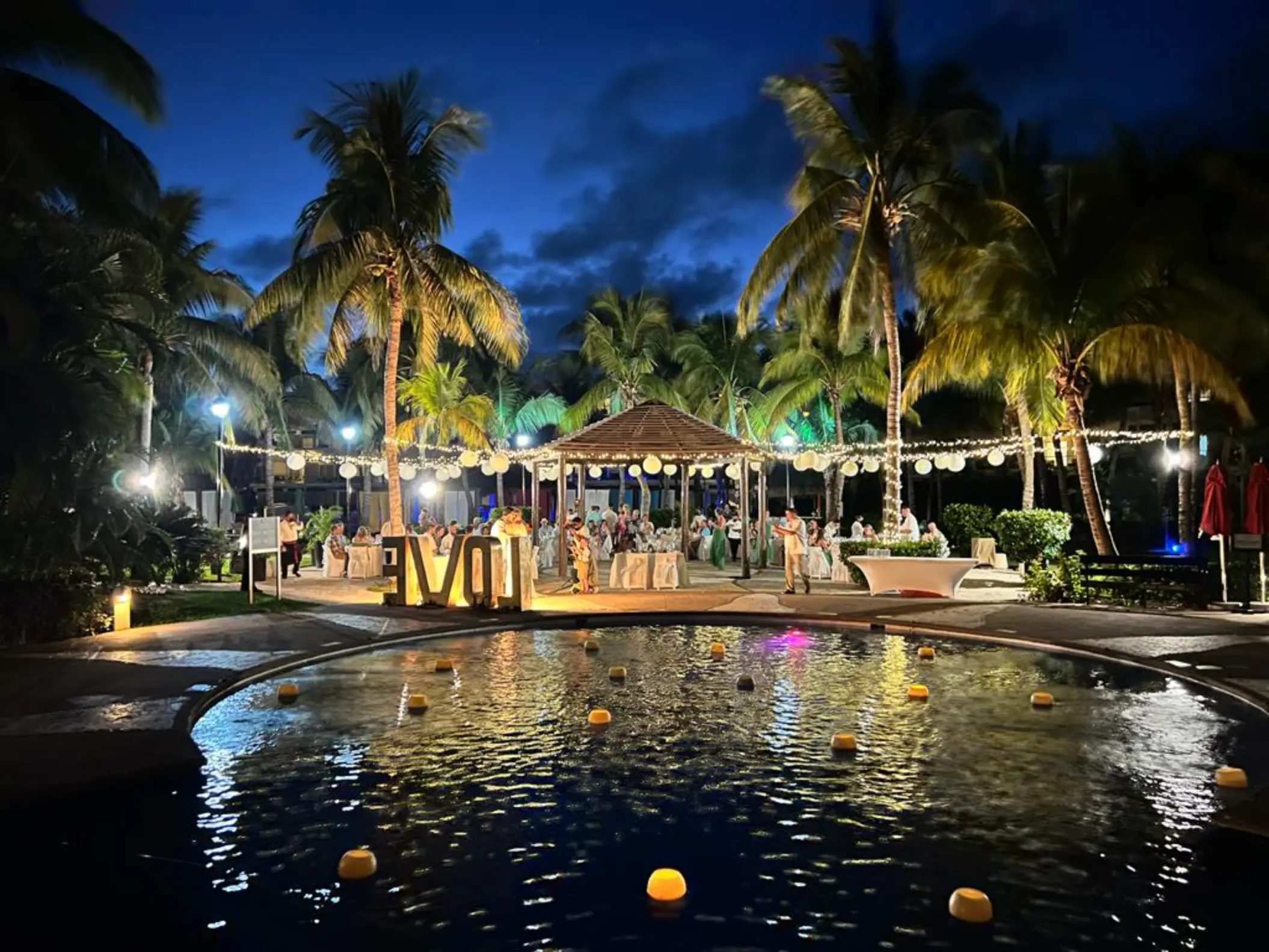 Evening wedding reception by the pool at Iberostar Selection Riviera Cancun