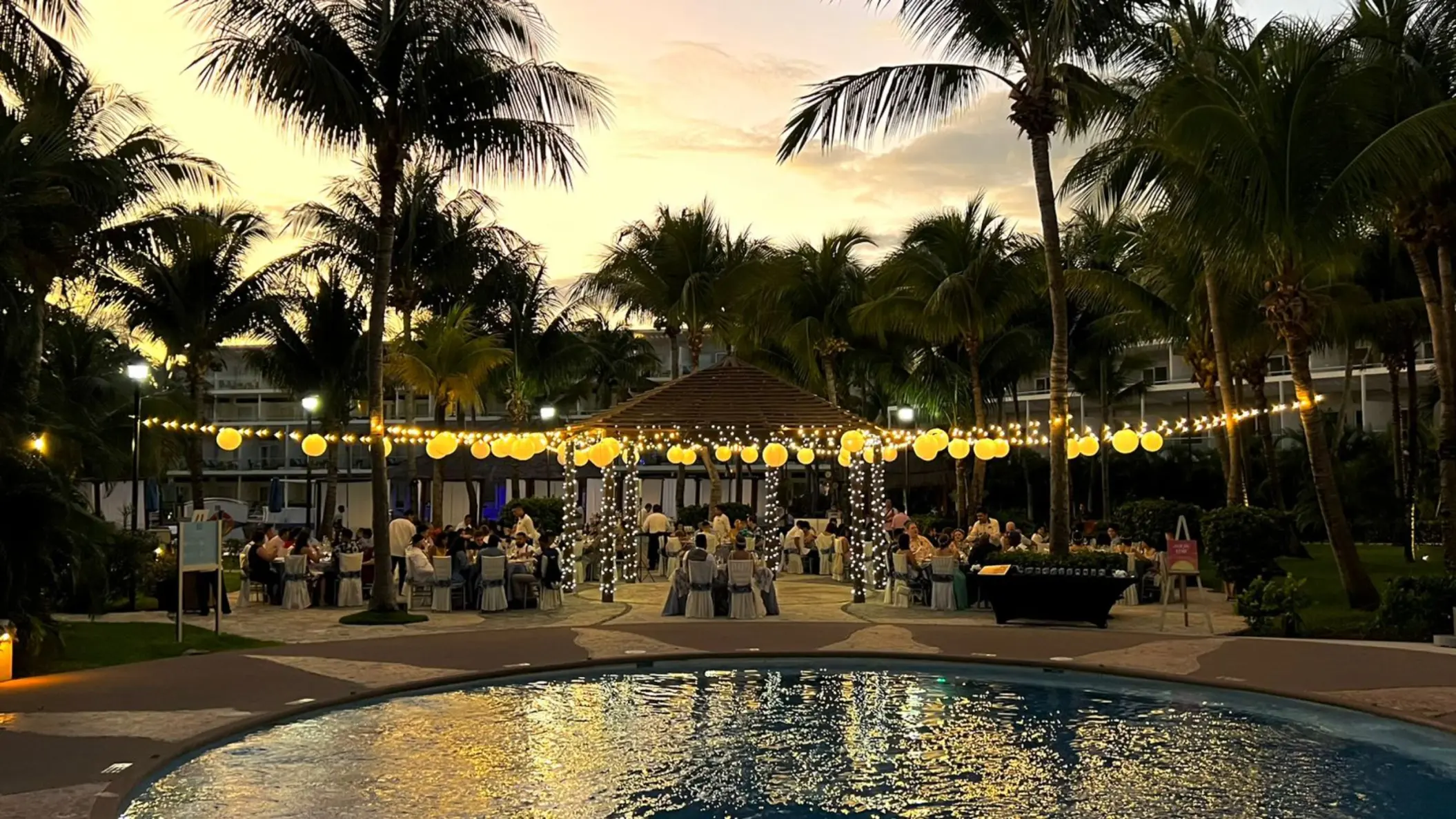 Outdoor wedding reception with string lights and lanterns at Iberostar Selection Riviera Cancun, Cancun