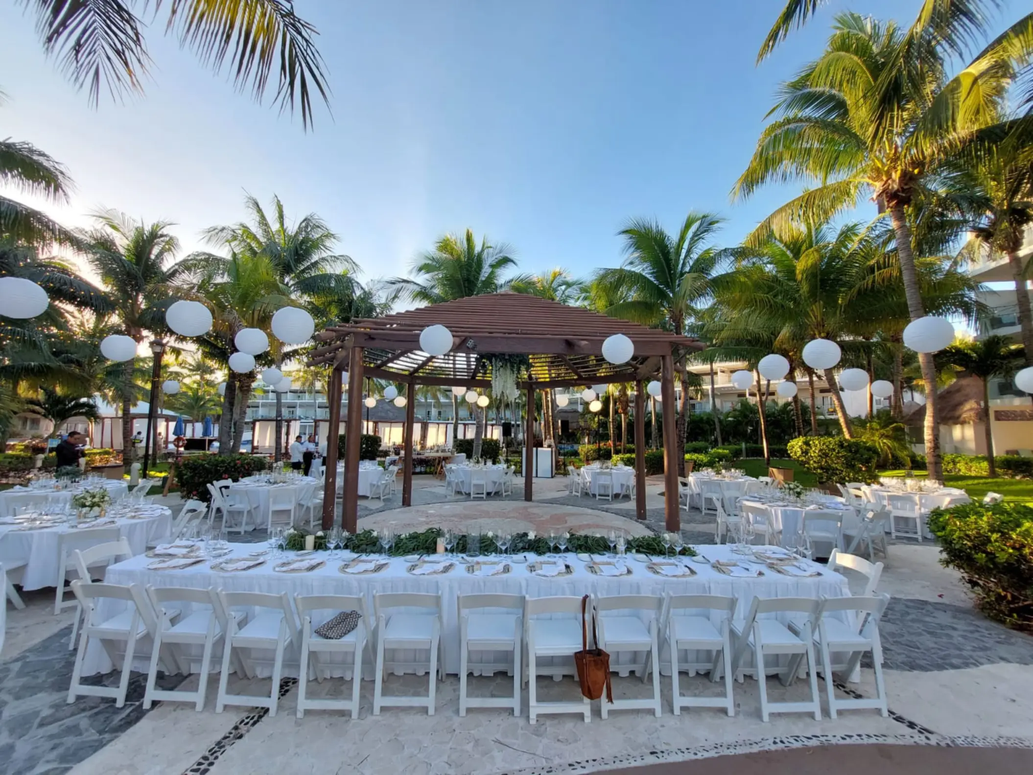 Plaza del Sol garden wedding reception setup with white paper lanterns at Iberostar Selection Riviera Cancun, Cancun