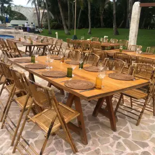 Outdoor wedding reception setup with wooden tables and bamboo chairs at Iberostar Selection Riviera Cancun, Cancun