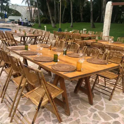 Outdoor wedding reception setup with wooden tables and bamboo chairs at Iberostar Selection Riviera Cancun, Cancun