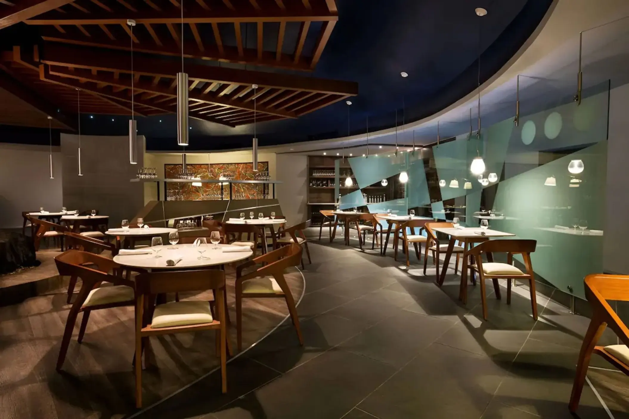 Modern indoor restaurant with wood accents and geometric glass walls at Iberostar Selection Riviera Cancun, Cancun