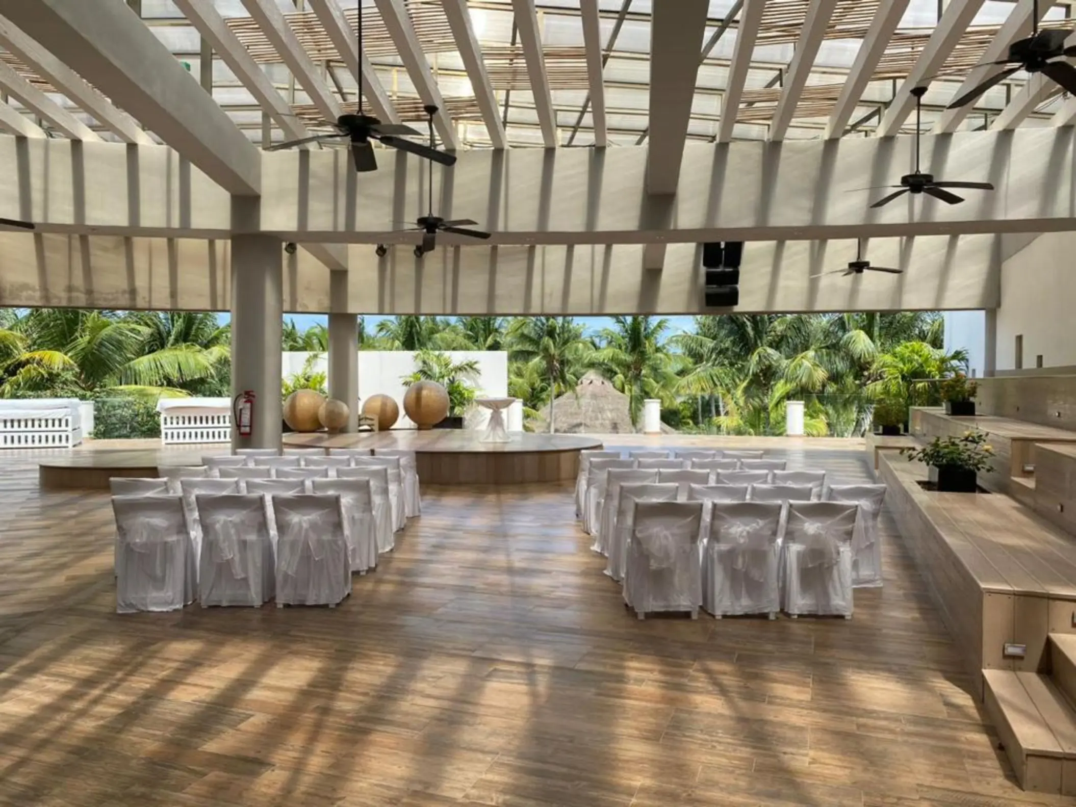 Roof garden wedding ceremony venue with white chairs and pergola at Iberostar Selection Riviera Cancun, Cancun