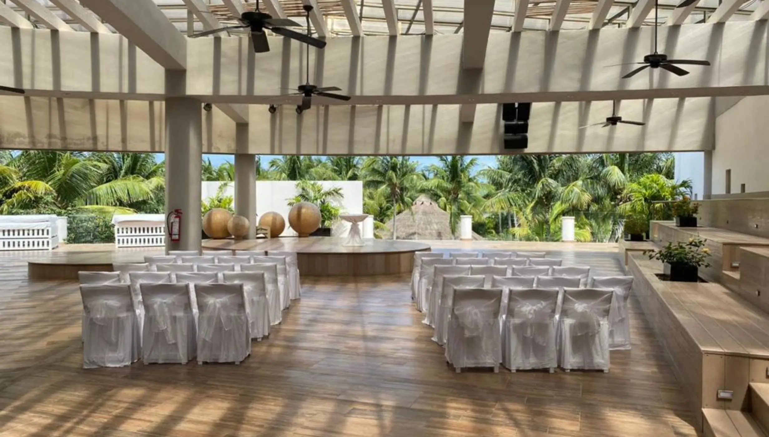 Roof garden wedding ceremony venue with white chairs and pergola at Iberostar Selection Riviera Cancun, Cancun