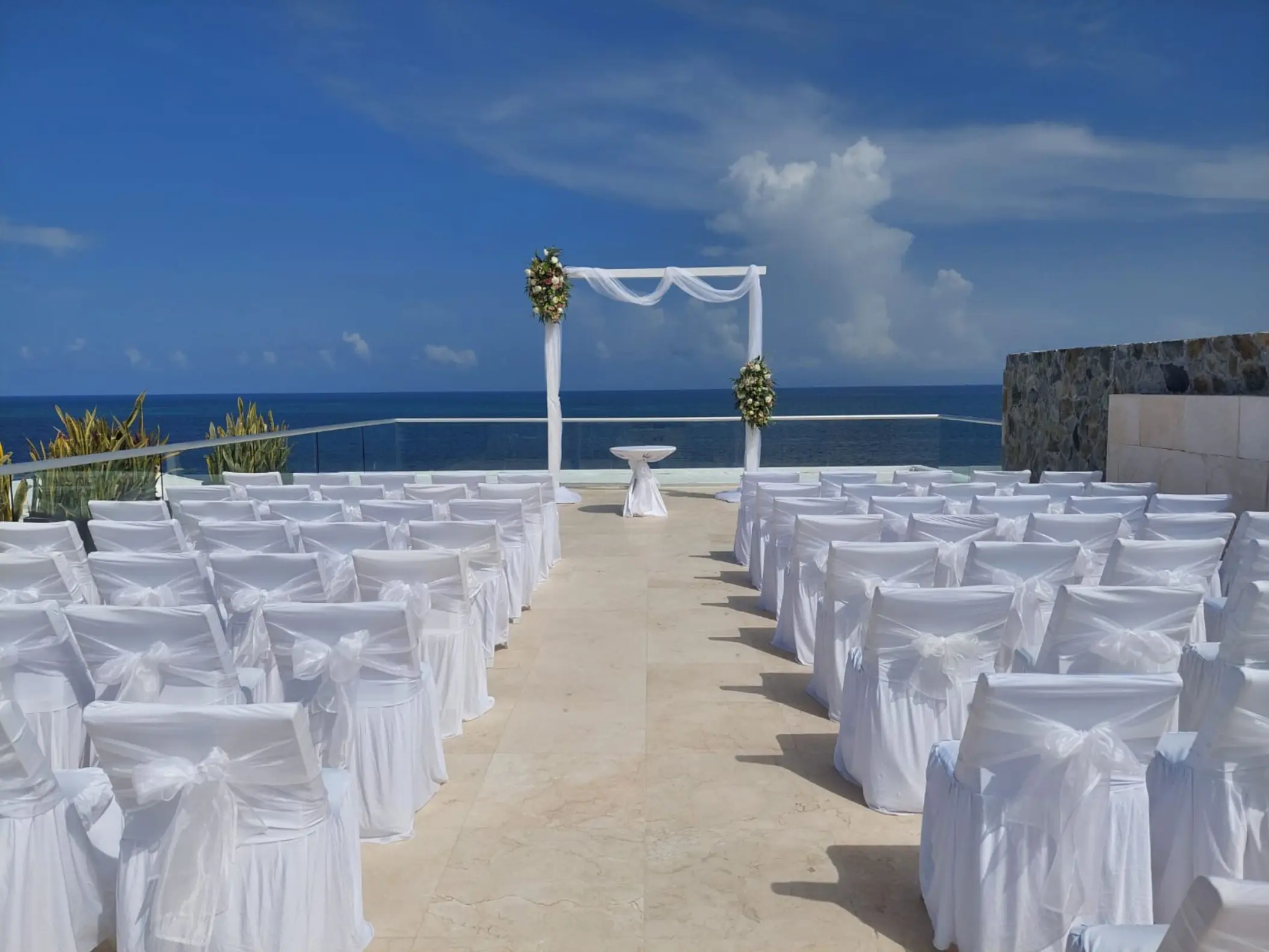 Rooftop wedding ceremony at Iberostar Selection Riviera Cancun with white seating and ocean views