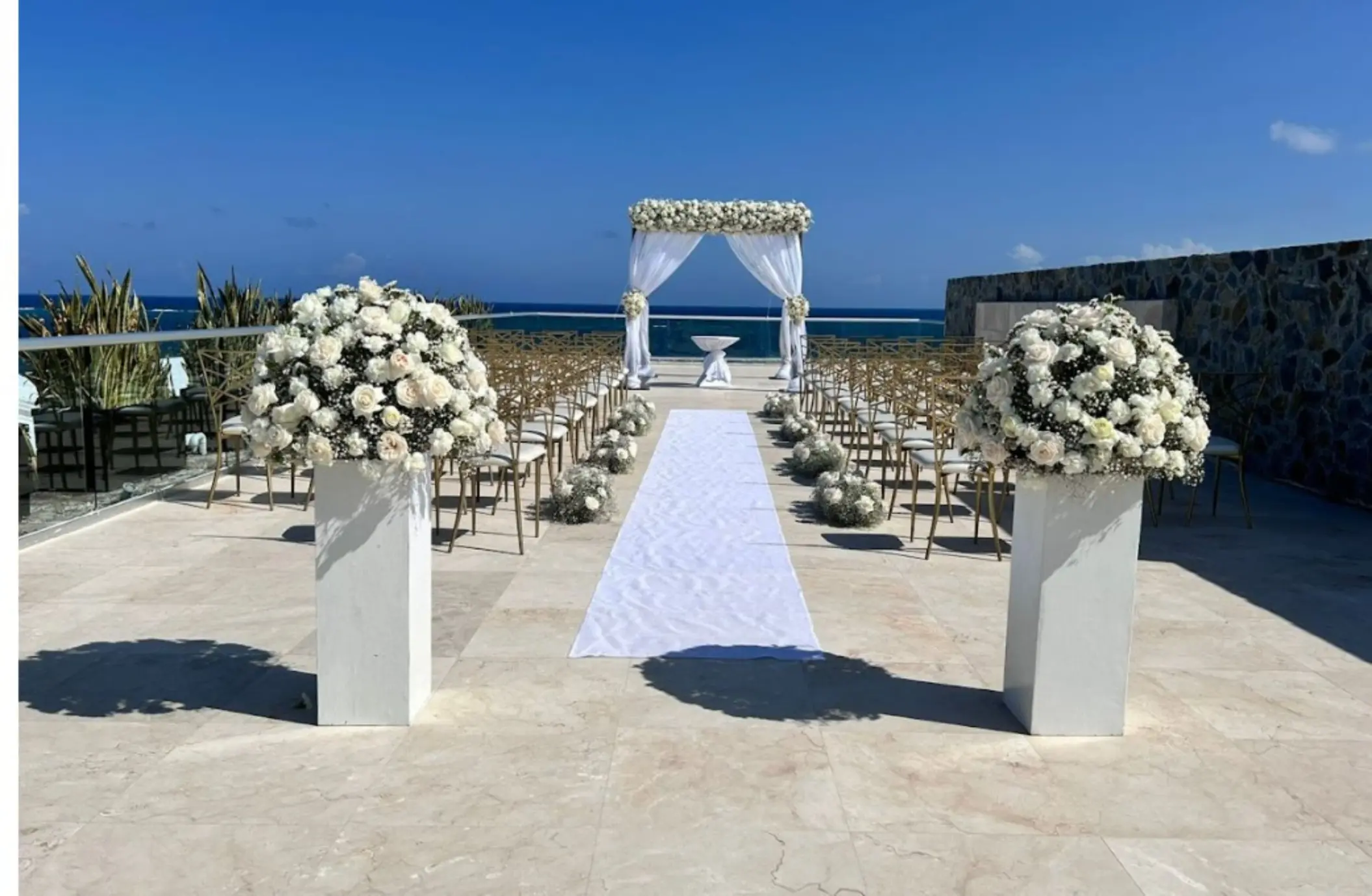Rooftop wedding ceremony with floral arch and aisle at Iberostar Selection Riviera Cancun, Cancun