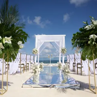 Rooftop wedding ceremony with white huppah and mirrored aisle at Iberostar Selection Riviera Cancun