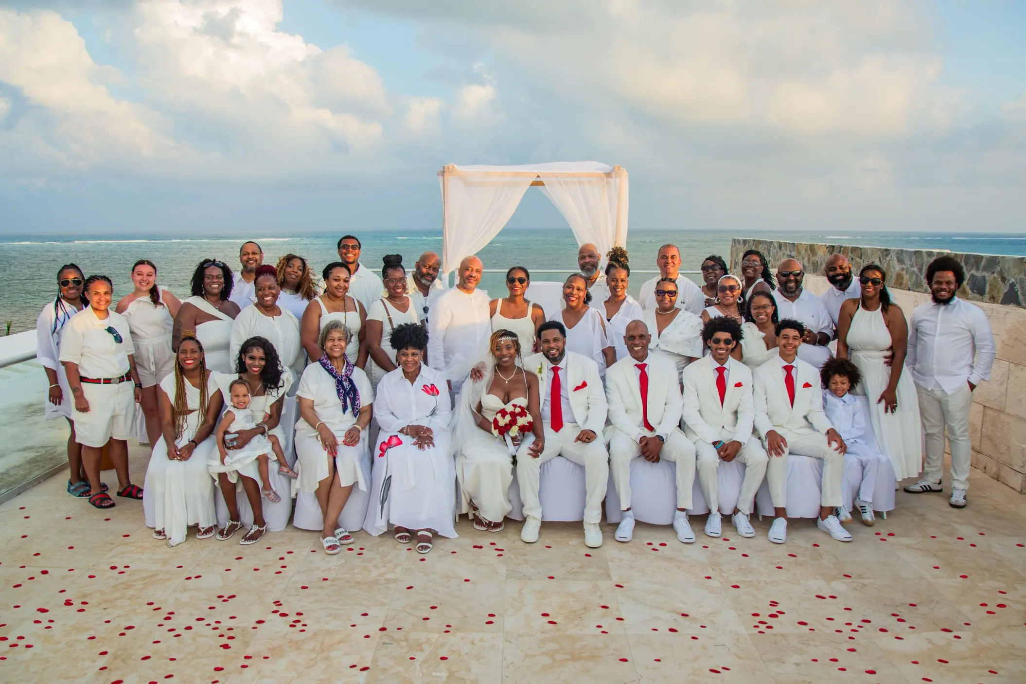 Large wedding group wearing white at Iberostar Selection Riviera Cancun oceanfront rooftop terrace, Cancun
