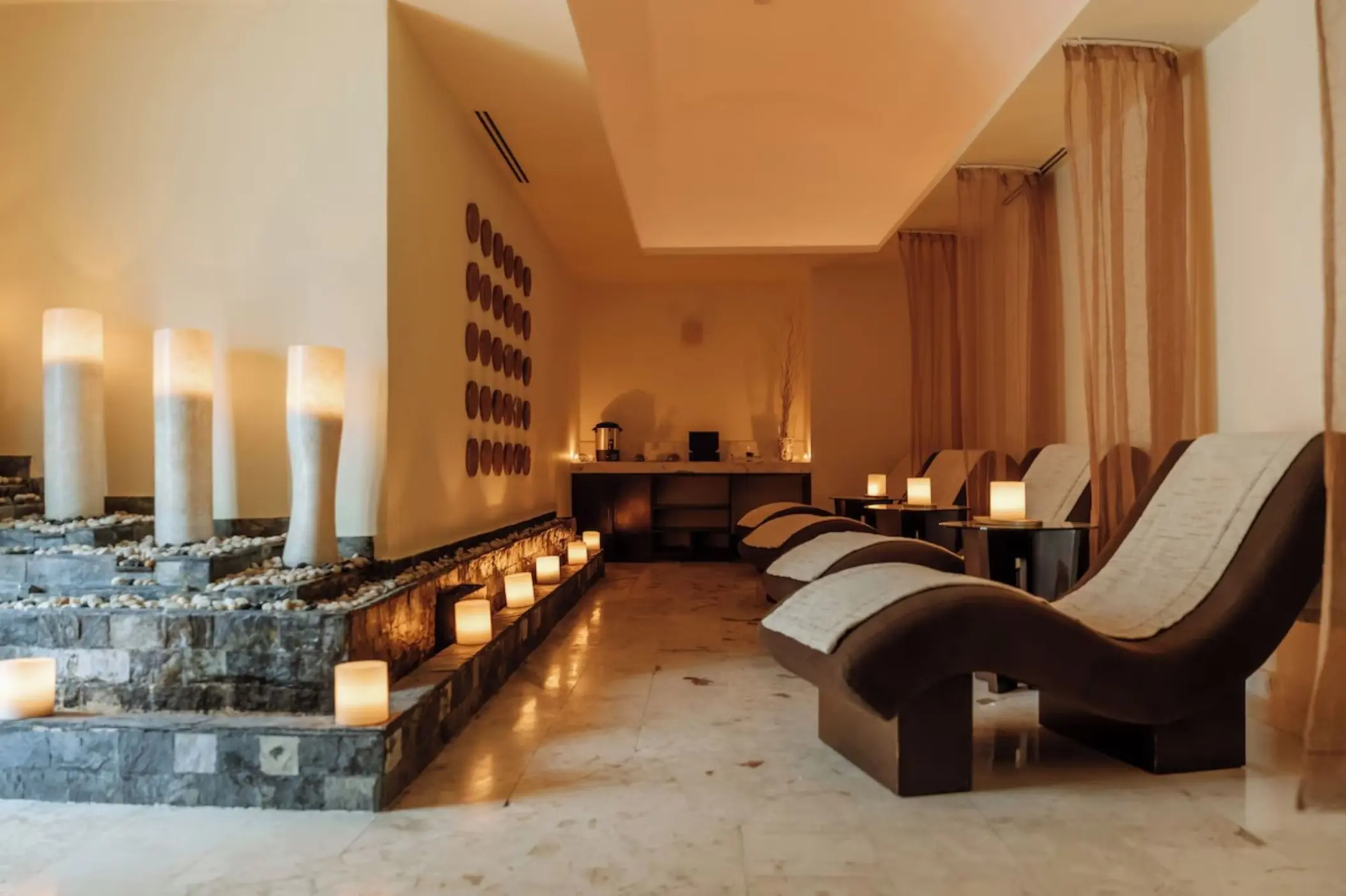 Relaxation lounge with curved spa loungers and candle lighting at Iberostar Selection Riviera Cancun, Cancun