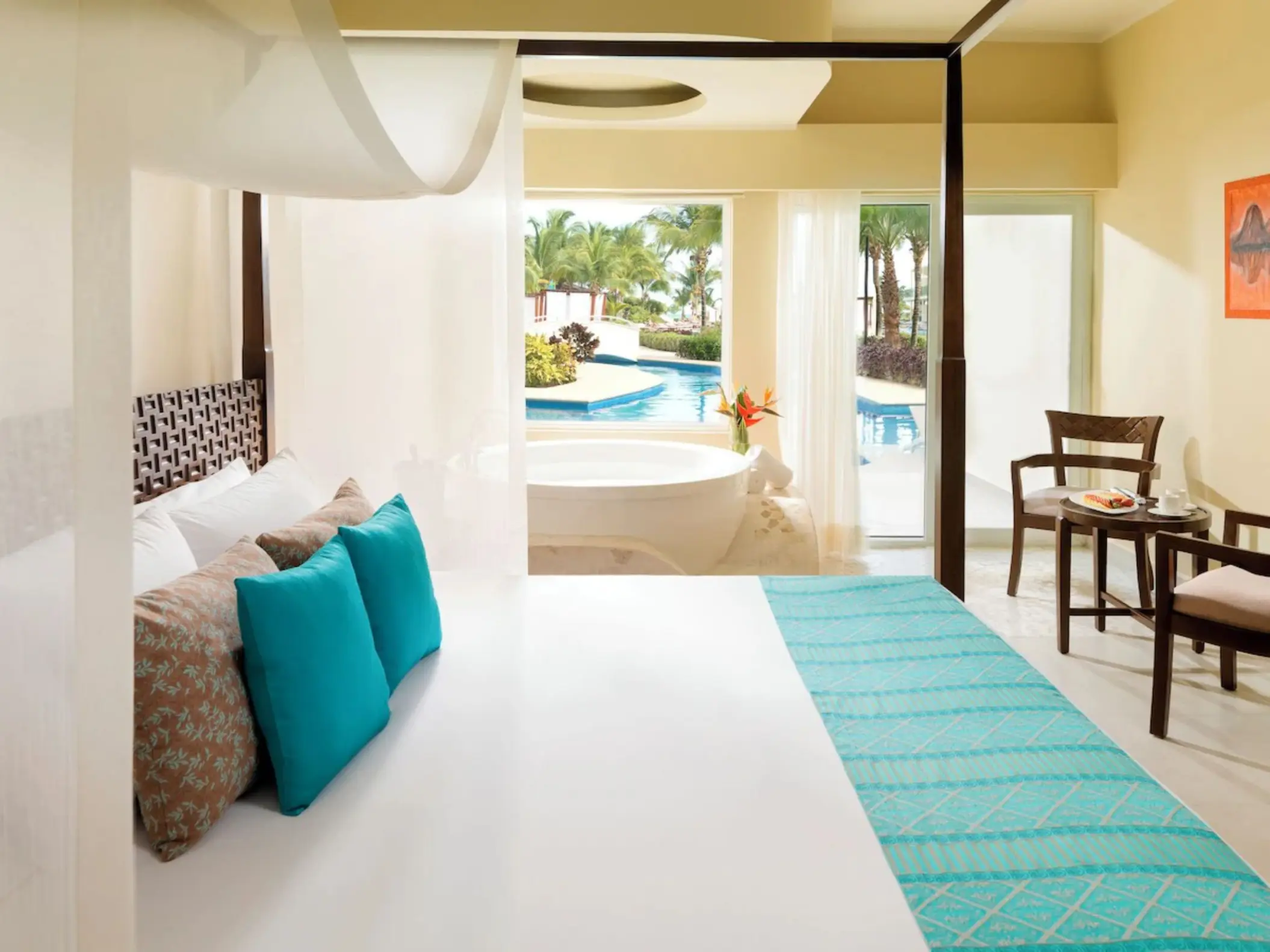 Iberostar Selection Riviera Cancun guest suite with canopy bed and whirlpool tub, Cancun
