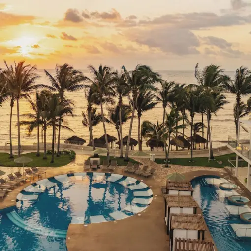 Sunset over the pool and beachfront suites at Iberostar Selection Riviera Cancun, Cancun