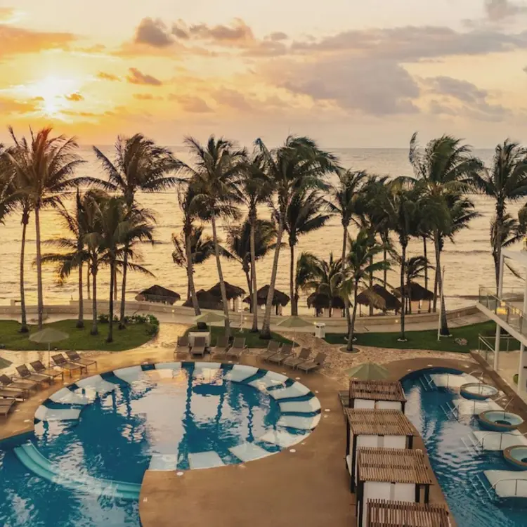 Sunset over the pool and beachfront suites at Iberostar Selection Riviera Cancun, Cancun