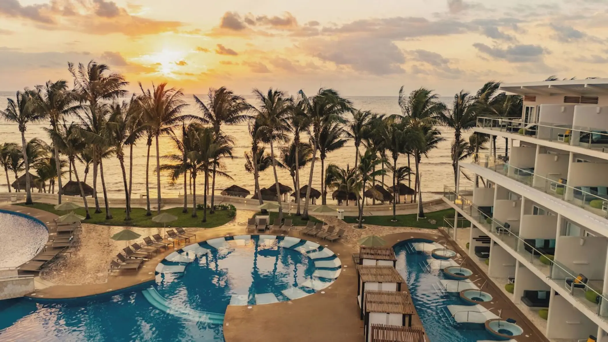 Sunset over the pool and beachfront suites at Iberostar Selection Riviera Cancun, Cancun