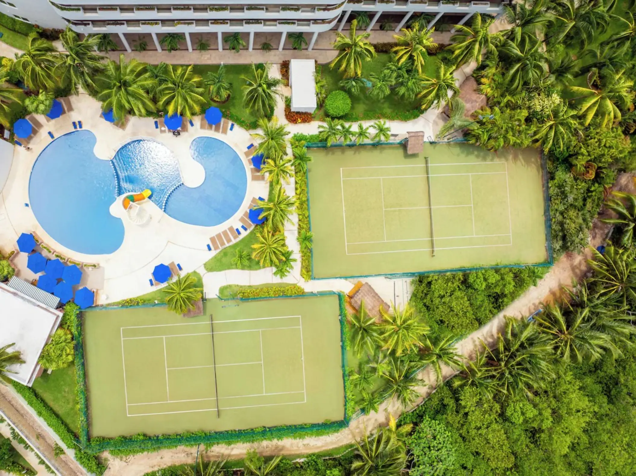 Aerial view of tennis courts and swimming pool at Iberostar Selection Riviera Cancun, Cancun