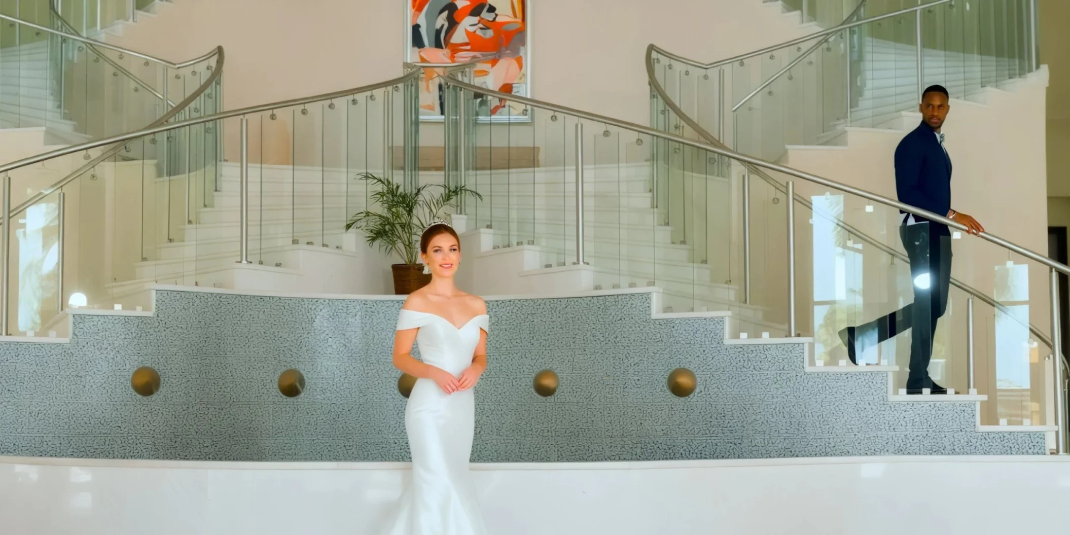 Bride and groom at the lobby staircase venue Iberostar Selection Rose Hall Suites