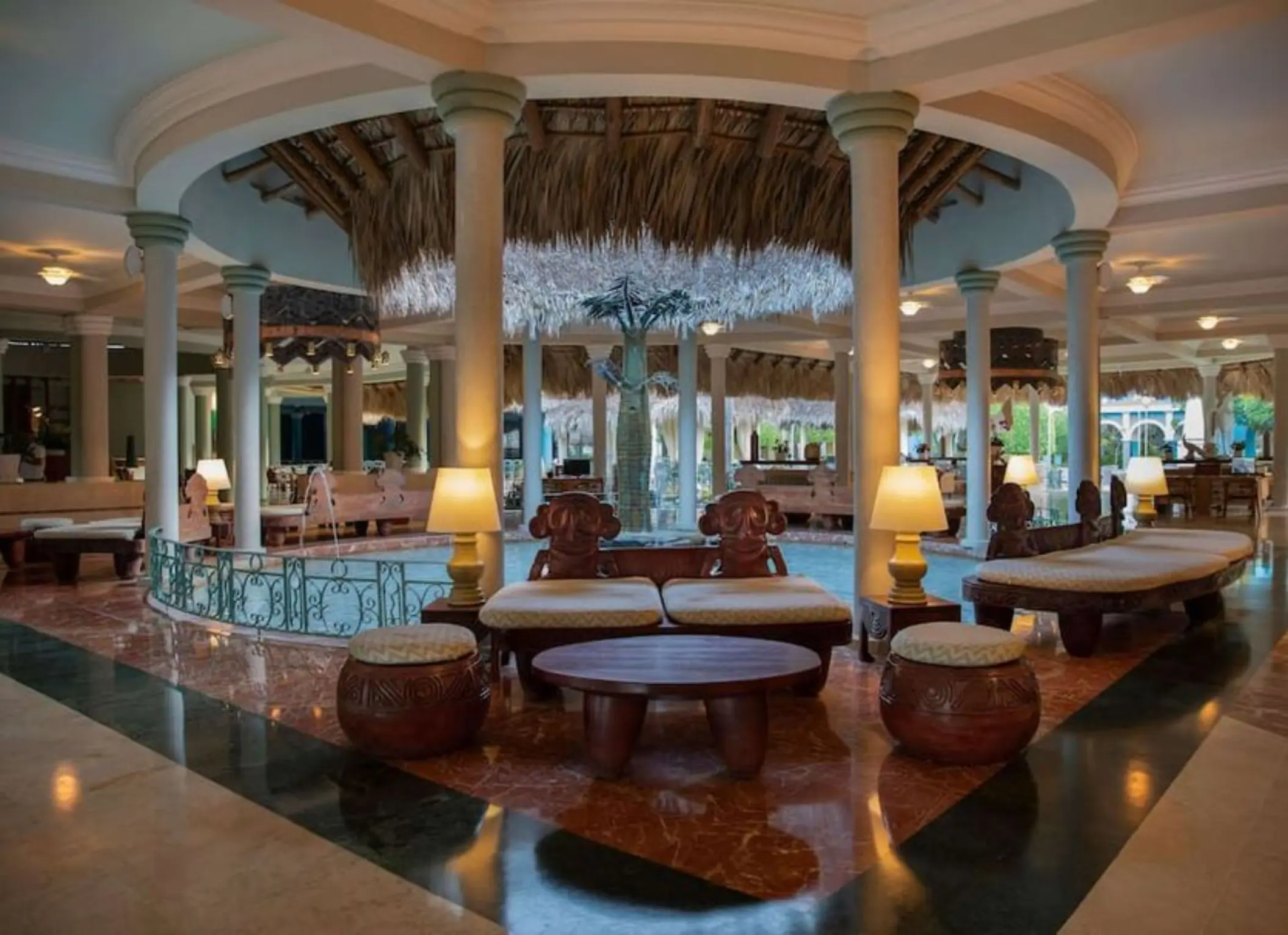 Open-air lobby with columns and a thatched roof centerpiece at Iberostar Waves Costa Dorada, Puerto Plata