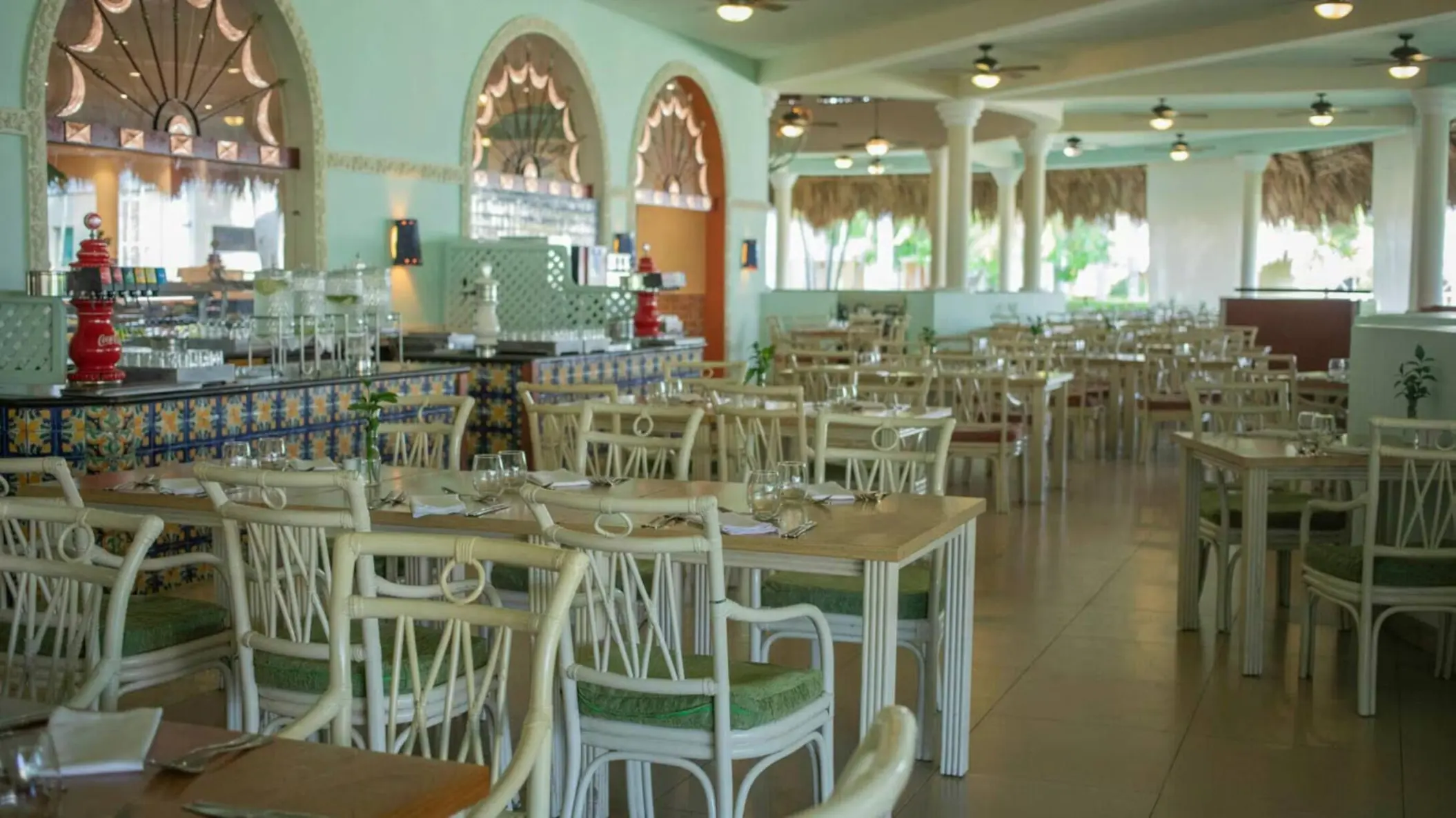 Mexican restaurant with white wicker chairs and arched windows at Iberostar Waves Costa Dorada, Puerto Plata