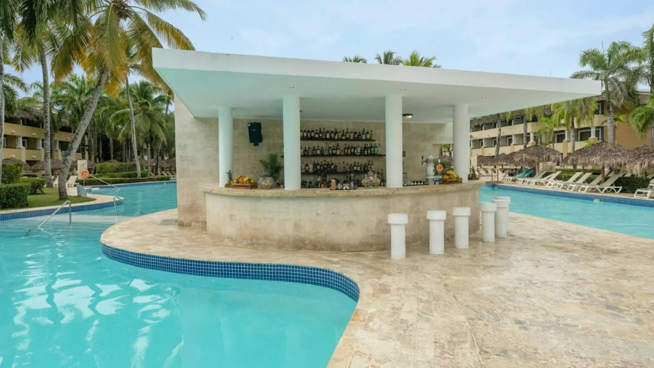 Swim-up bar with white stools at Iberostar Waves Costa Dorada, Puerto Plata