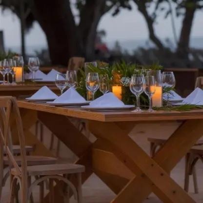 Outdoor wedding reception setup with wooden tables and candles at Iberostar Waves Costa Dorada, Puerto Plata