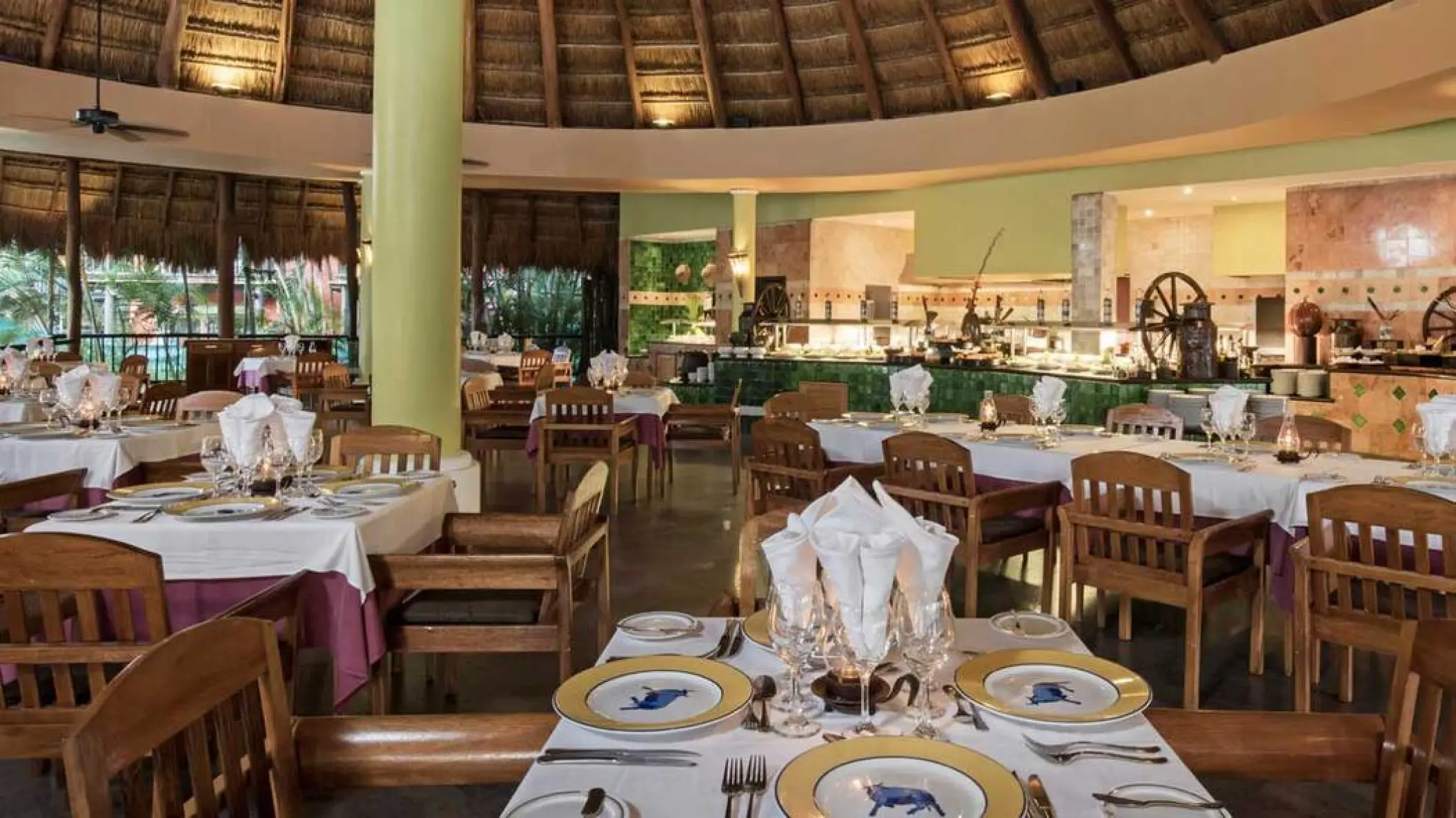Buffet restaurant dining area with a palapa roof at Iberostar Waves Cozumel