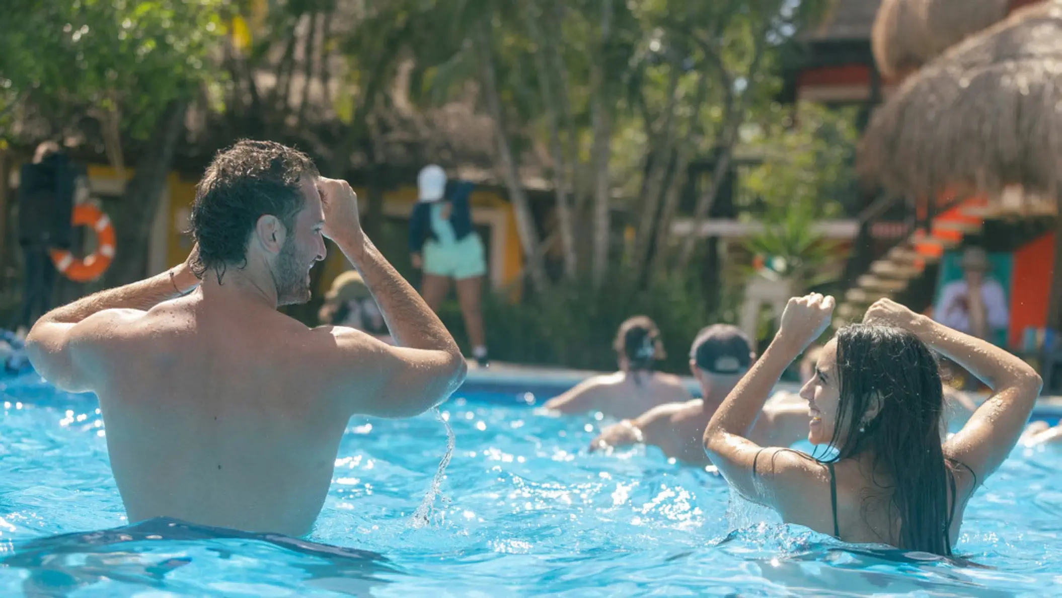 Couple dancing during pool aerobics at Iberostar Waves Cozumel